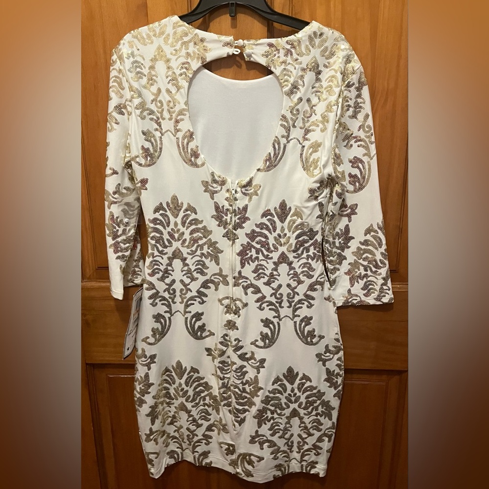 White dress with gold sequins.